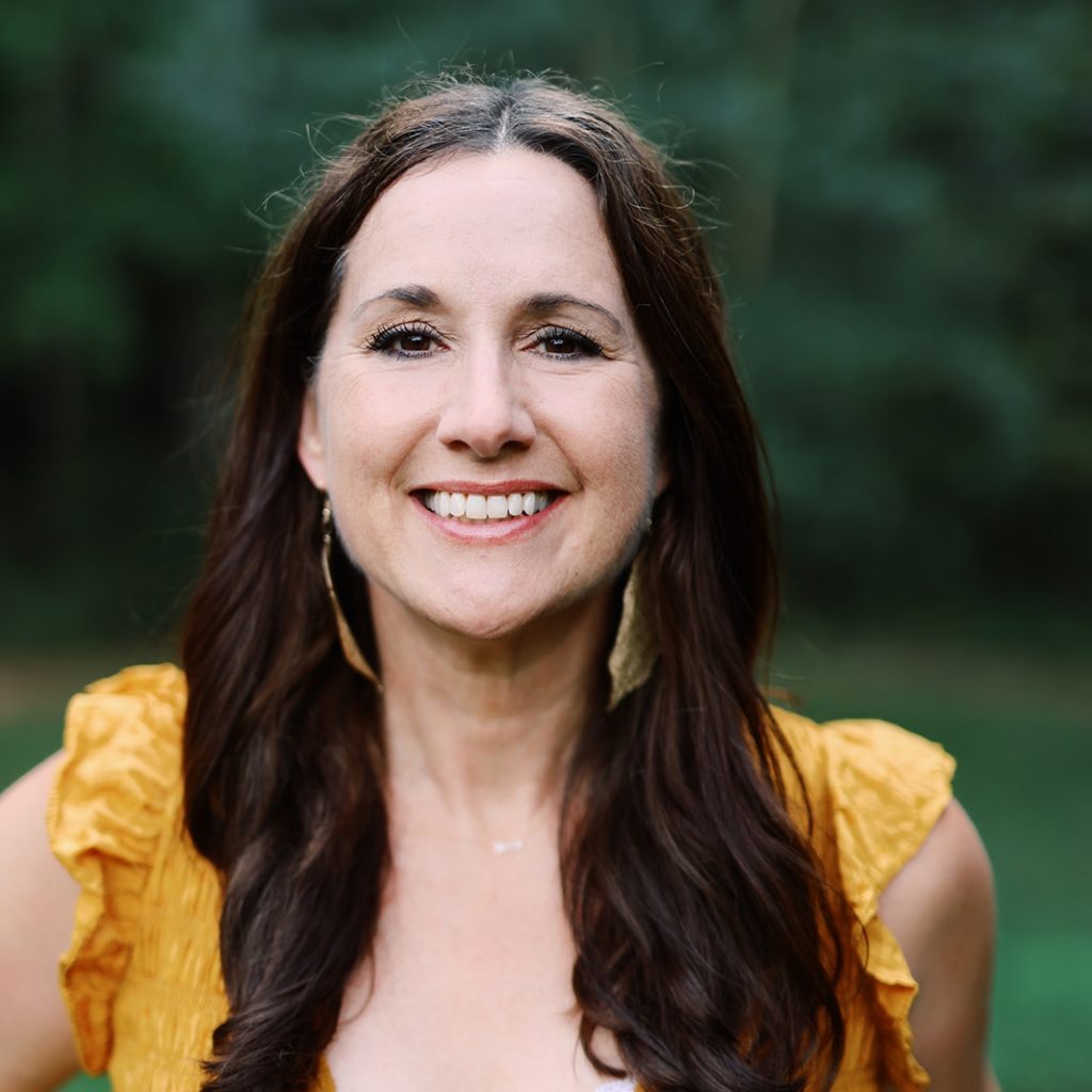 Author Stephanie Sarazin smiling in a yellow shirt